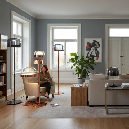 Lysverden modern floor and table lamps with smoked glass domes and gold accents in a stylish living room setting.