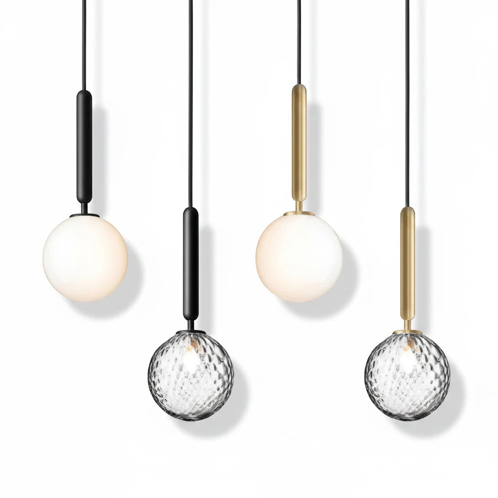 Lysverden glass pendant lamps with opal and faceted clear glass globes on black and gold metal stems.