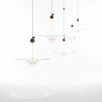 Lysverden glass pendant lamps with clear glass bowls and gold accents hanging in a decorative cluster