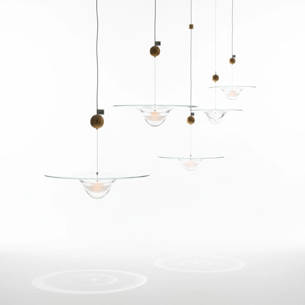 Lysverden glass pendant lamps with clear glass bowls and gold accents hanging in a decorative cluster