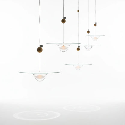 Lysverden glass pendant lamps with clear glass bowls and gold accents hanging in a decorative cluster