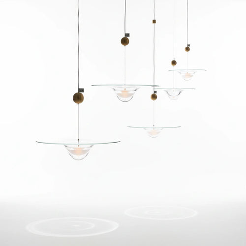 Lysverden glass pendant lamps with clear glass bowls and gold accents hanging in a decorative cluster