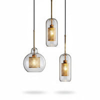 Lysverden glass pendant lights with clear glass shades and gold metal mesh inserts in a modern industrial style.