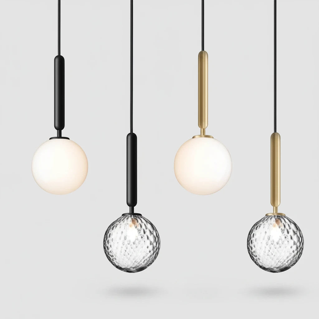 Lysverden glass pendant lamps with opal and faceted clear glass spheres on black and gold stems hanging in a row