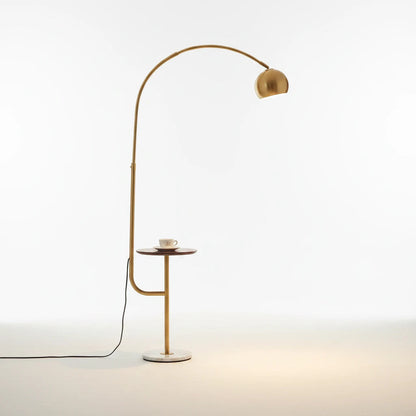 Lysverden arched floor lamp in gold metal with a white marble base and integrated side table against a white background