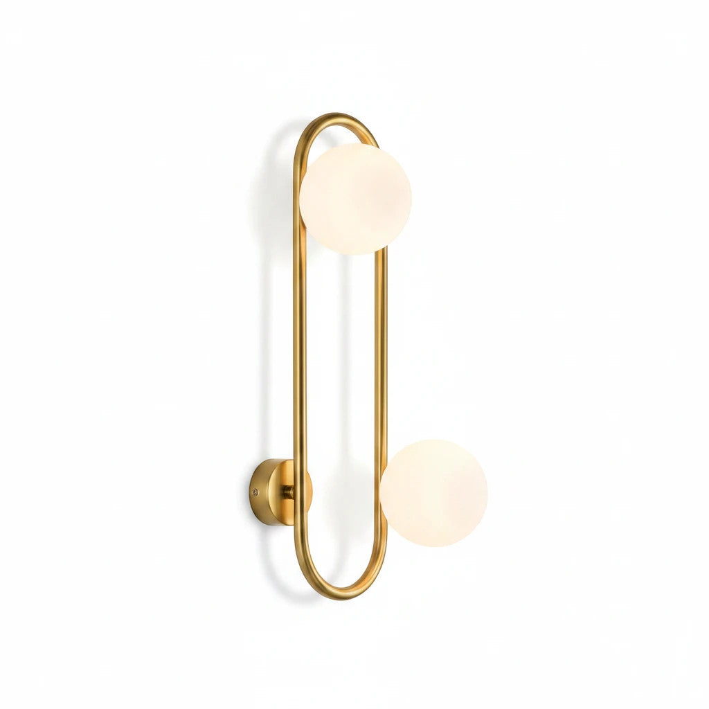 Lysverden midt-century wall lamp featuring a gold brass oval ring and two white frosted glass globe shades.