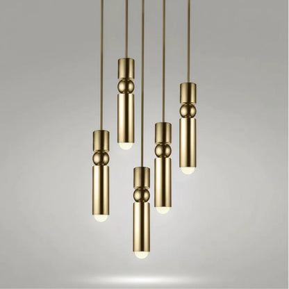 Lysverden gold cylinder pendant lights with sphere details hanging in a cluster for modern interior lighting