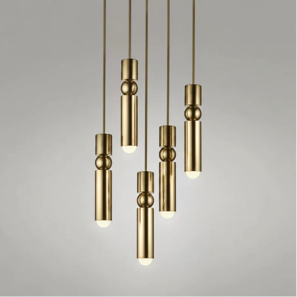 Lysverden gold cylinder pendant lights with spherical details hanging in a cluster for modern interior lighting