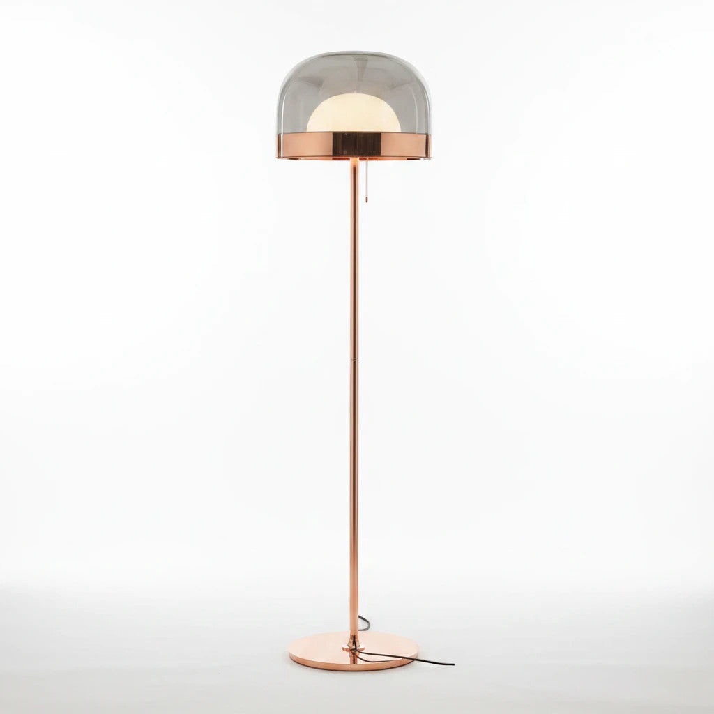 Lysverden floor lamp with a gold metal stand and a smoked grey glass dome featuring an internal opal light source.