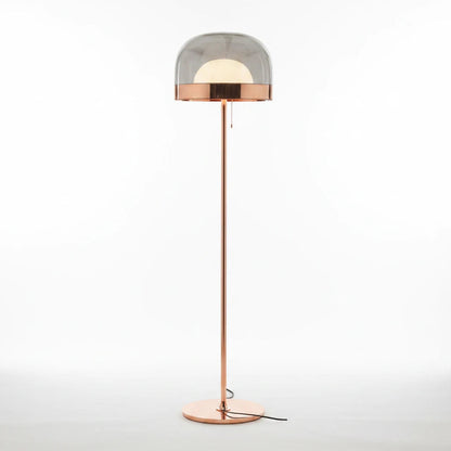 Lysverden floor lamp with a gold metal stand and a smoked grey glass dome featuring an internal opal light source.