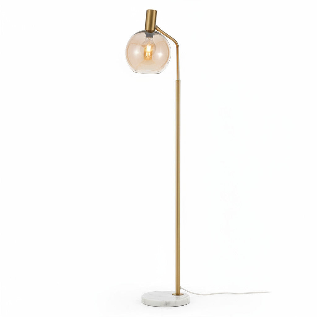 Lysverden floor lamp with a gold metal stem, amber glass globe shade, and a circular white marble base.
