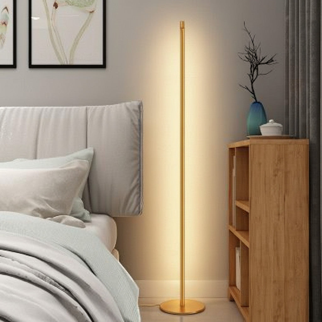 Lysverden minimalist gold LED floor lamp with a slim metal rod design providing soft indirect light in a bedroom corner