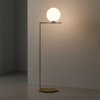 Lysverden gold floor lamp with a glowing opal glass sphere shade and a minimalist metal frame in a modern interior.