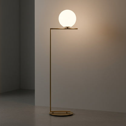 Lysverden gold floor lamp with a glowing opal glass sphere shade and a minimalist metal frame in a modern interior.