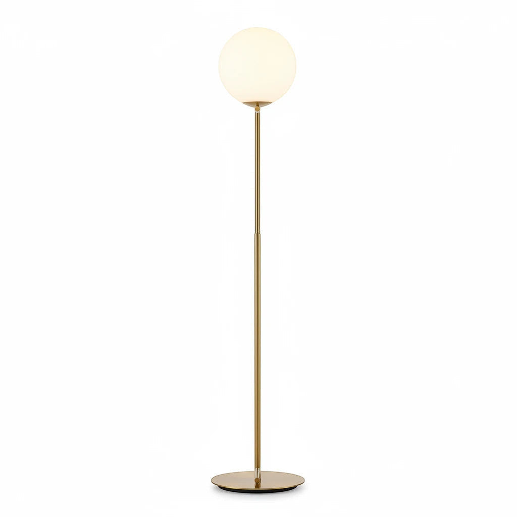 Lysverden floor lamp in gold with a minimalist metal stand and a spherical opal glass shade for soft diffused light.