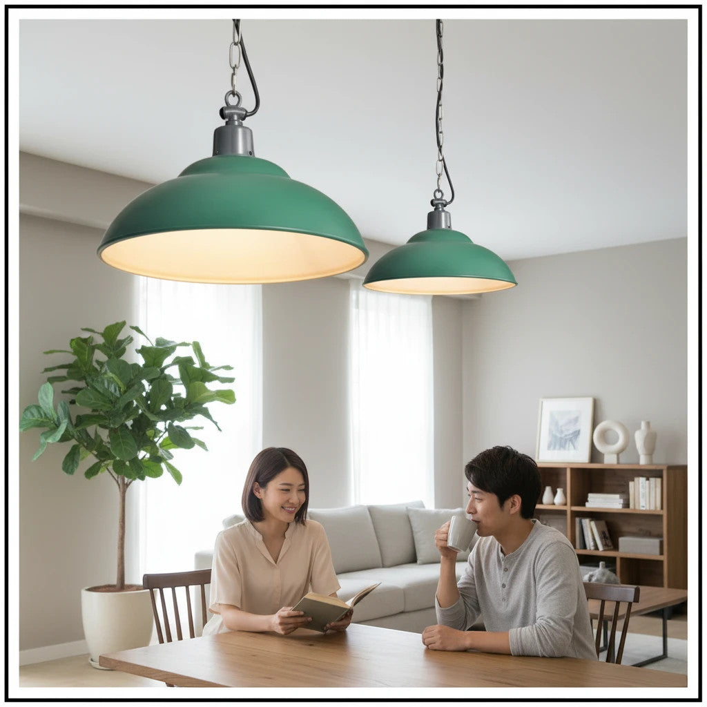 Lysverden green metal dome pendant lights hanging over a wooden dining table with a couple sitting in a cozy living room