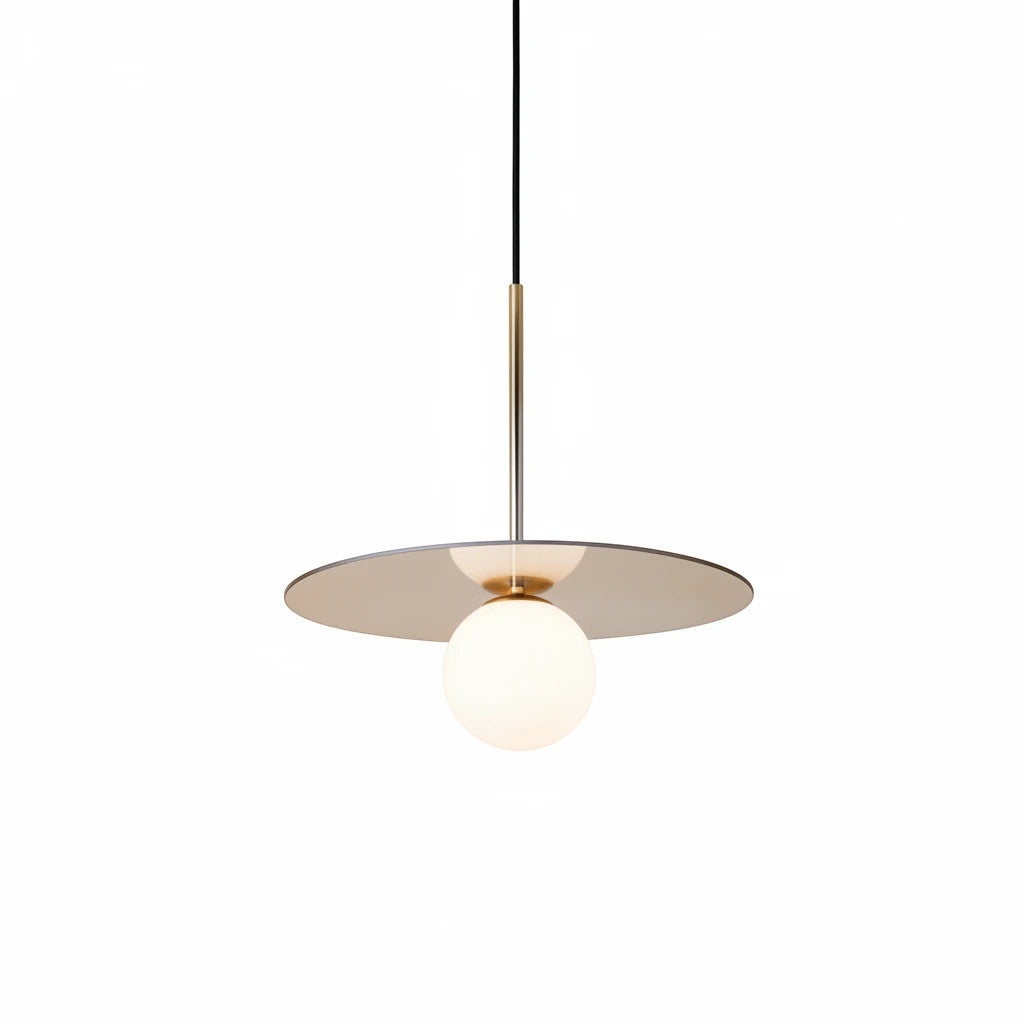 Lysverden Gulldisk pendant lamp featuring a gold disc and white opal glass sphere for soft, minimalist lighting.