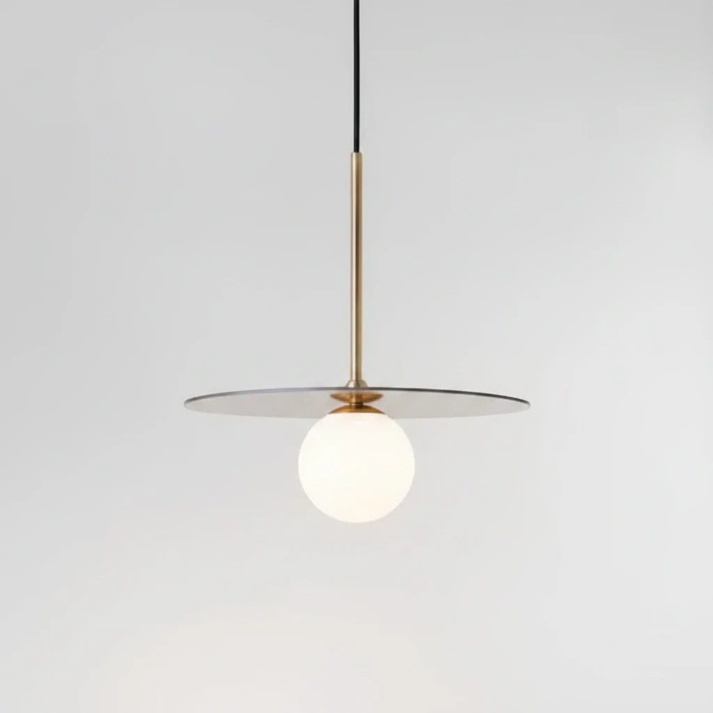 Lysverden Gulldisk pendant lamp featuring a gold metal disc and a white opal glass sphere for soft ambient lighting.