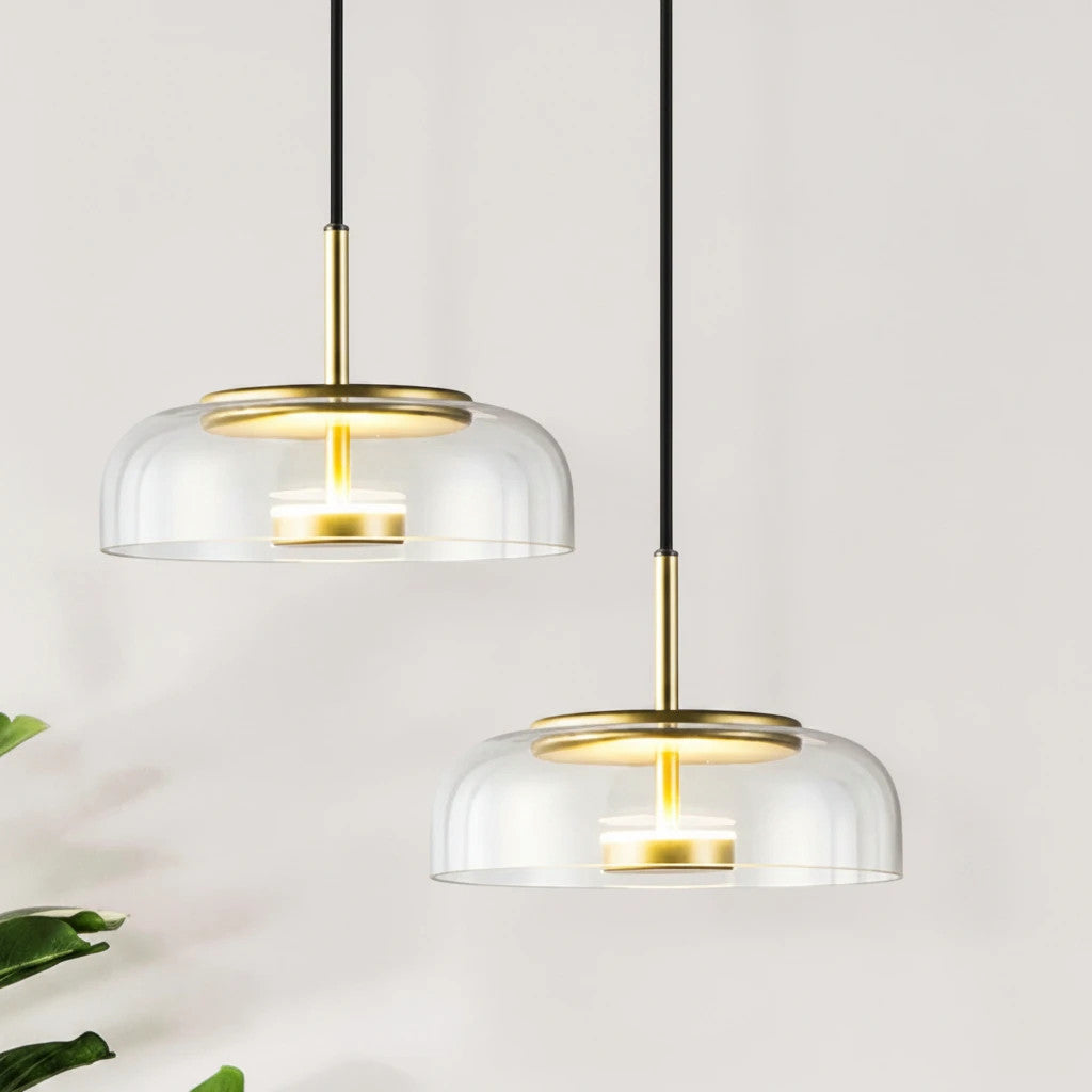 Lysverden KUPPEL pendant lights with clear glass domes and polished brass reflectors for elegant dining room lighting.