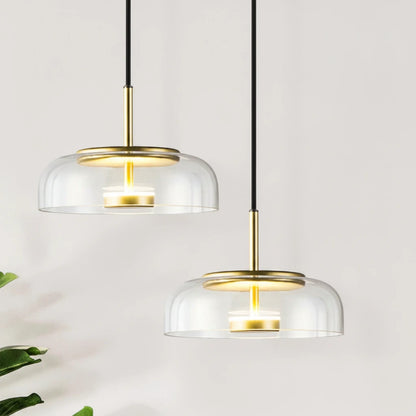 Lysverden KUPPEL pendant lights with clear glass domes and polished brass reflectors for elegant dining room lighting.