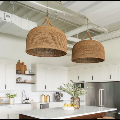 Lysverden large dome-shaped natural rattan pendant lights hanging over a modern kitchen island with white cabinets.
