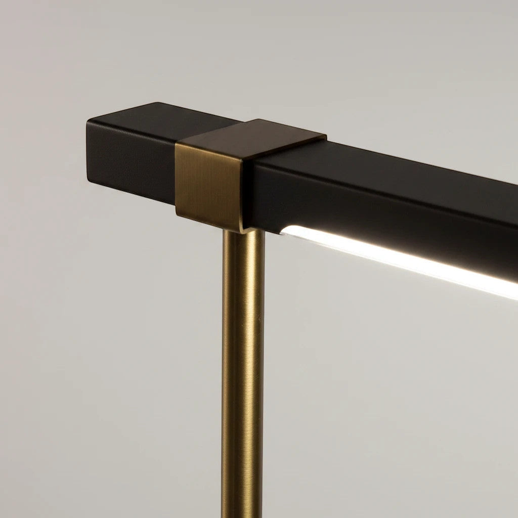 Lysverden Scandinavian LED lamp with a sleek black bar and brushed brass metal details in a minimalist design.