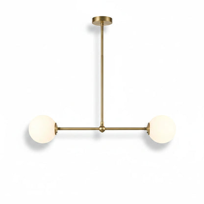 Lysverden linear pendant lamp with brass finish and two opal white glass globes in a mid-century modern style.