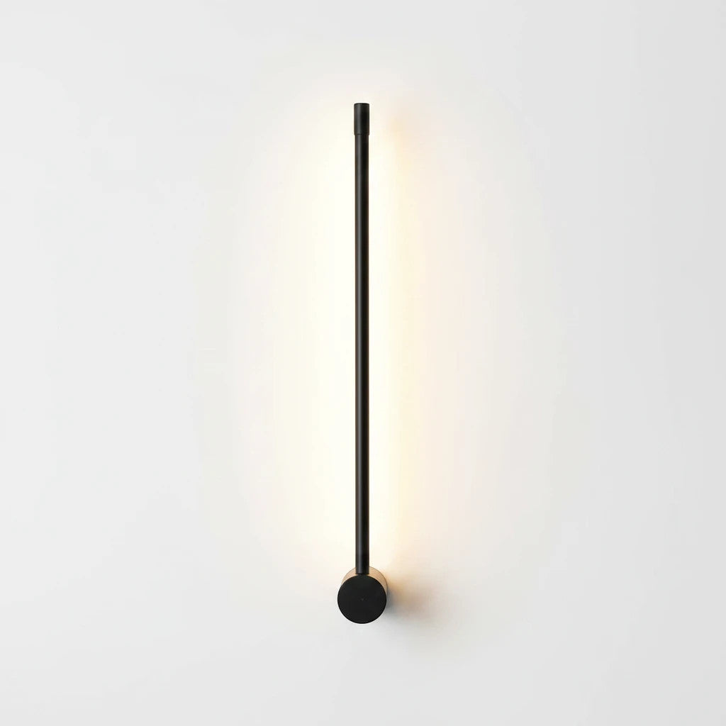 Lysverden LYS minimalist black linear LED wall lamp casting a warm glow on a white wall