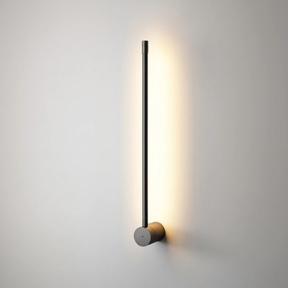 Lysverden LYS linear black LED wall lamp with a minimalist vertical design casting a warm glow on a light wall