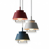 Lysverden Macaron pendant lamps in burgundy, grey, and blue with layered metal shades and warm glowing bulbs.