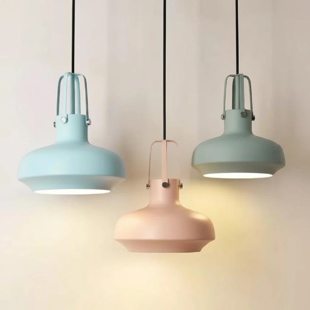 Lysverden Macaron metal pendant lamps in soft pastel blue, pink, and green hanging in a row with downward lighting.