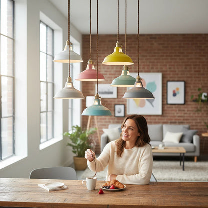 Lysverden Macaron pendant lights in pastel colors with wooden details hanging over a wooden dining table with a woman