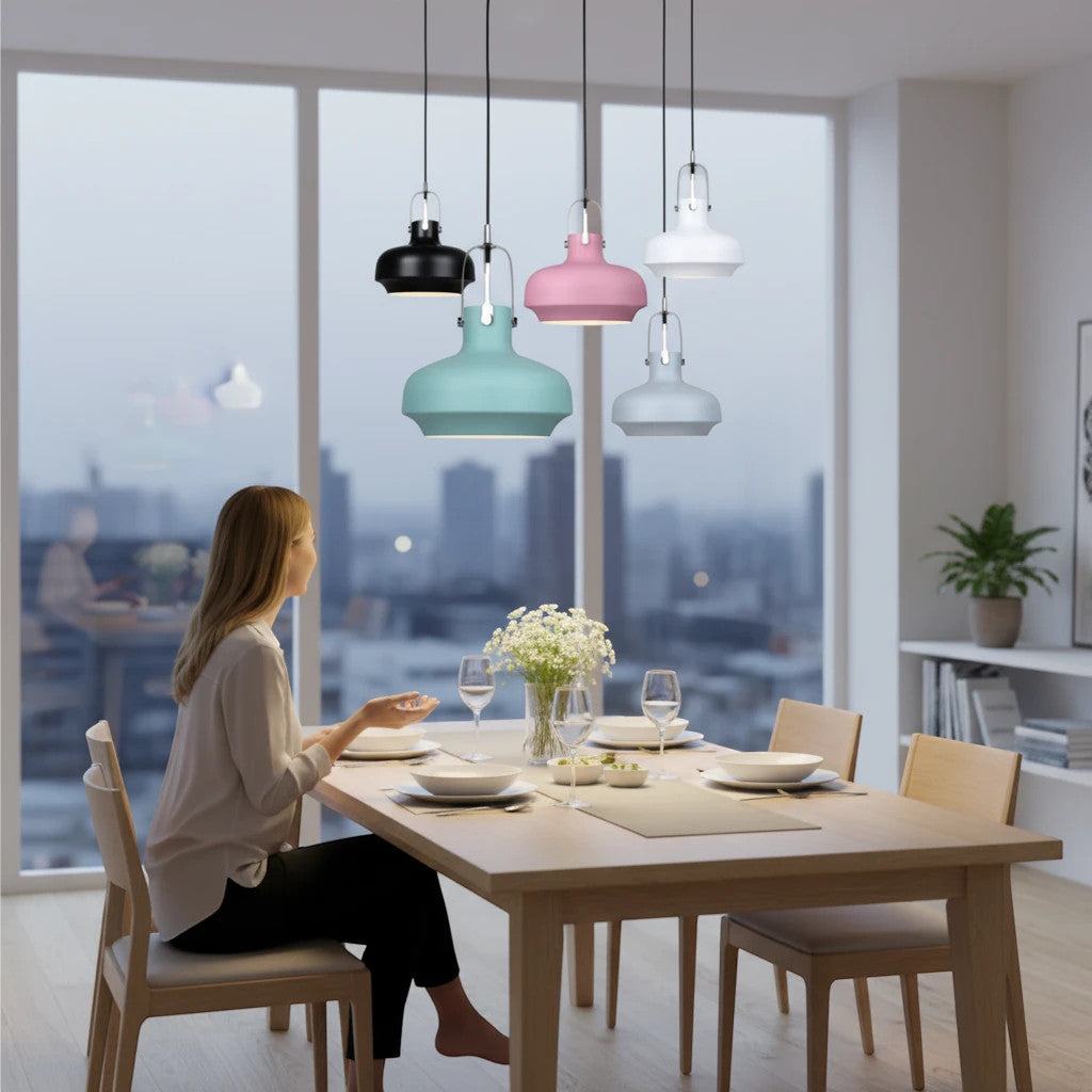 Lysverden Macaron pendant lights in pastel and neutral colors hanging over a dining table in a modern home interior.