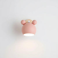 Lysverden Macaron wall lamp in pastel pink with a wooden base and adjustable spotlight design for Nordic interiors.