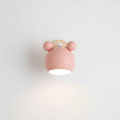 Lysverden Macaron wall lamp in pastel pink with a wooden base and adjustable spotlight design for Nordic interiors.