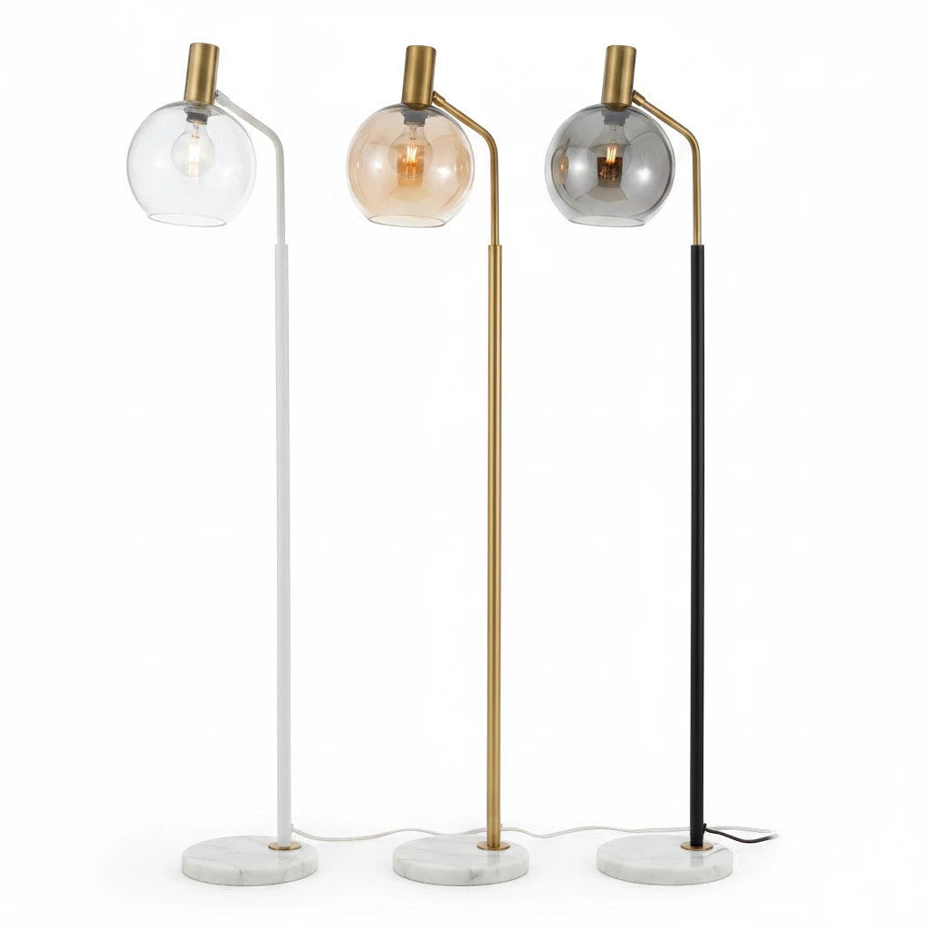 Lysverden floor lamps with marble bases, metal stems, and glass globes in white, gold, and black finishes.