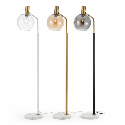 Lysverden floor lamps with marble bases, metal stems, and glass globes in white, gold, and black finishes.