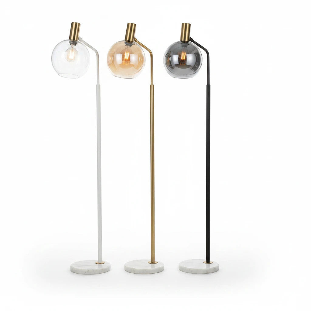 Lysverden minimalist floor lamps with marble bases, glass globes, and white, gold, and black metal stems.