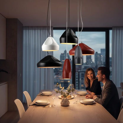 Lysverden ceramic pendant lights in matte black, white, and red hanging over a dining table with a couple