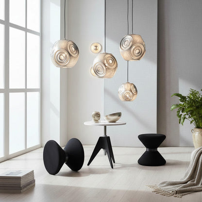 Lysverden sculptural metallic pendant lights with faceted surfaces hanging in a modern, bright living room interior.
