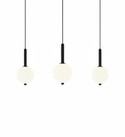 Lysverden minimalist LED pendant lights with glowing white spherical shades on slim black stems in a set of three.