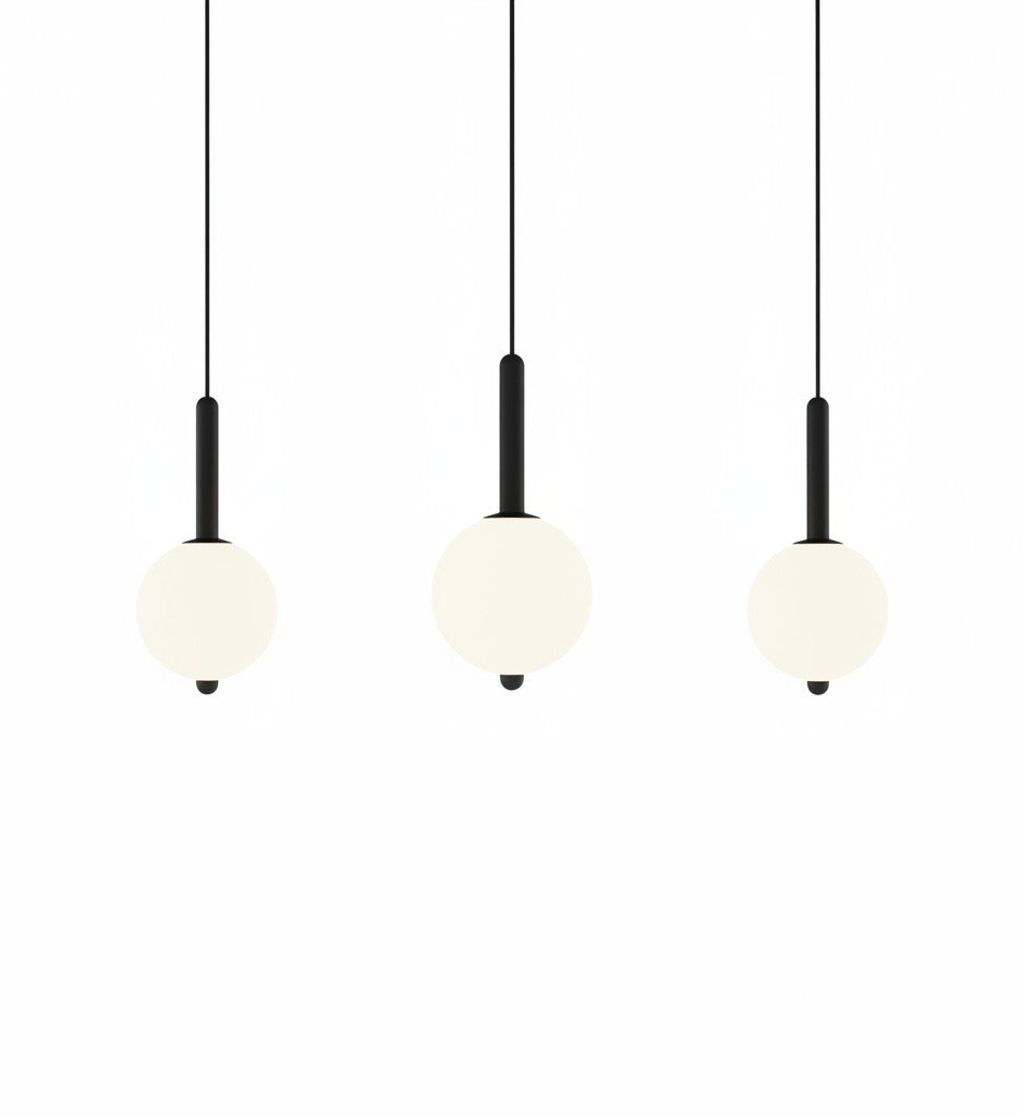Lysverden minimalist LED pendant lights with glowing white spherical shades on slim black stems in a set of three.