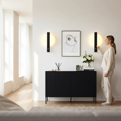Lysverden minimalist black and white circular LED wall lamps mounted on a white wall in a modern living room