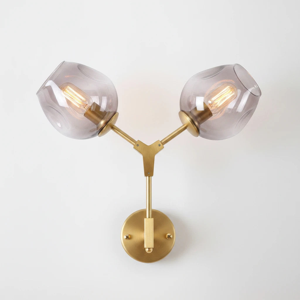 Lysverden mid-century wall lamp with two smoke-colored glass globes on a brushed brass fixture.