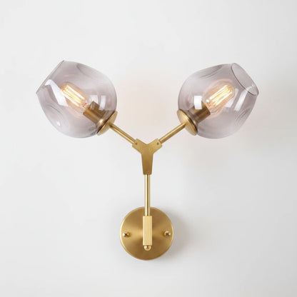Lysverden mid-century wall lamp with two smoke-colored glass globes on a brushed brass fixture.