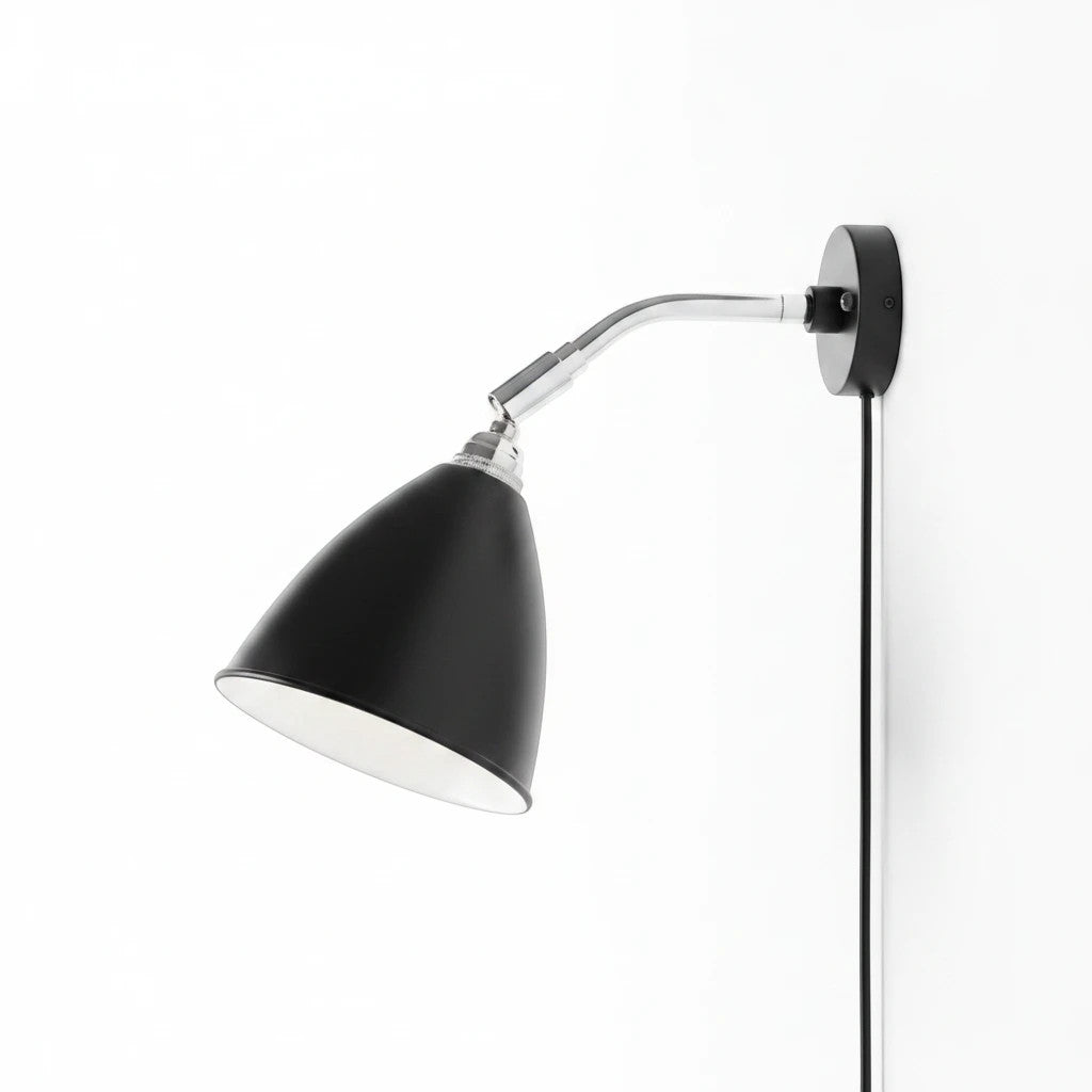 Lysverden Nordisk adjustable black wall lamp with a flexible chrome arm and conical shade for focused reading light.