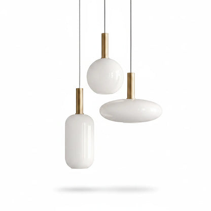 Lysverden opal glass pendant lamps with gold stems in three different shapes hanging against a white background