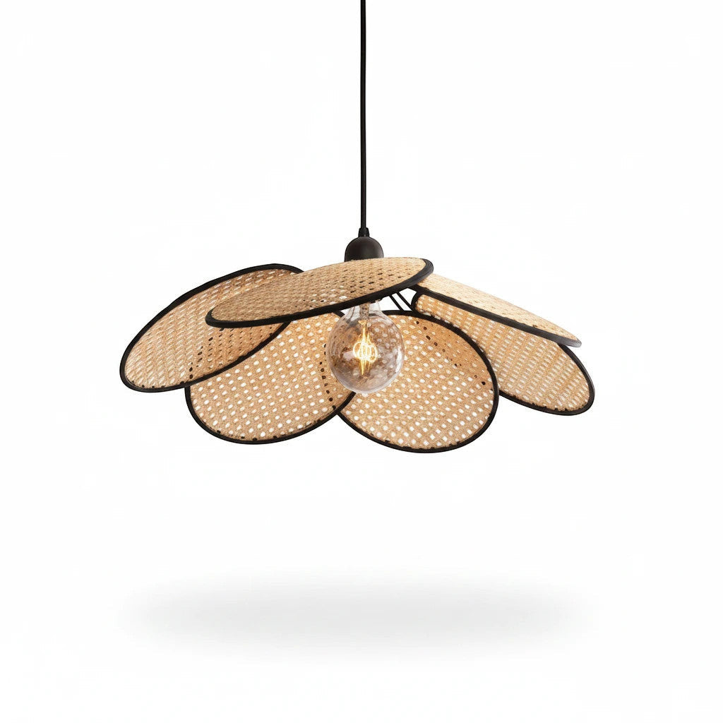 Lysverden flower-shaped rattan pendant lamp with woven natural cane petals and black edges for a boho interior style.