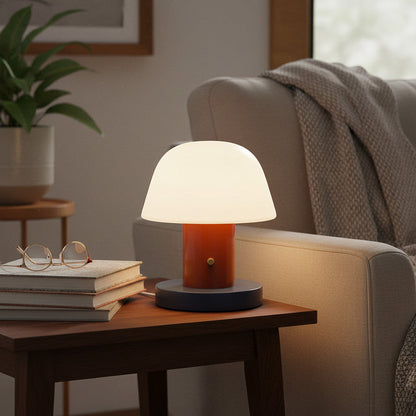 Lysverden retro mushroom table lamp with white opal shade, rust-colored stem, and navy base. Rechargeable, dimmable.