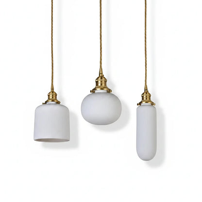 Lysverden RILLE pendant lights featuring three white ribbed opal glass shades with elegant brass hardware details.